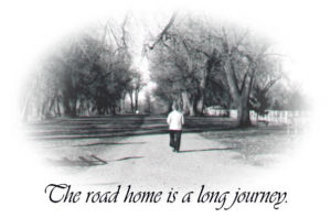 Black and white photo of an older woman walking down a gravel road.