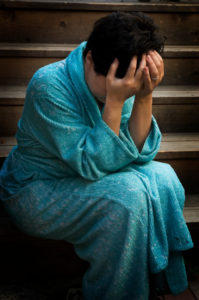 a woman in a robe feeling lost and alone