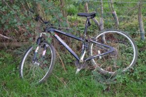 bicycle leaning on a fence