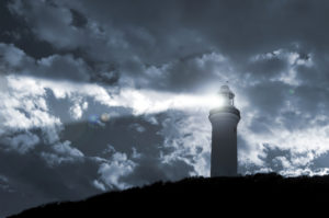 A lighthouse beacon in the clouds