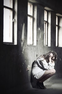 A disappointed woman against a wall