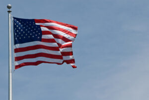 American flag waving against a blue sky