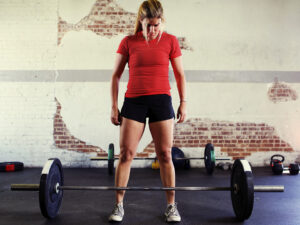 a woman bodybuilder looking at a weight