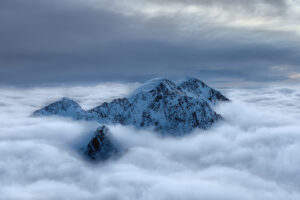 mountain peaks surrounded by clouds