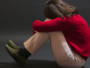 A girl in a red sweater crying