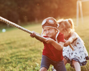 Two children playing tug-of-war