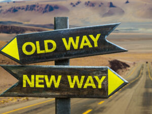 old way and new way signs pointing in opposite directions