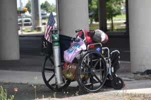 a man in a wheelchair with a heavy load