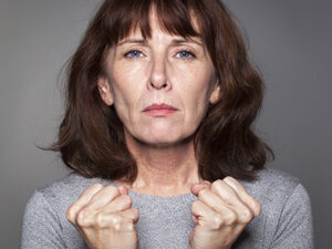 A woman with hands clasped
