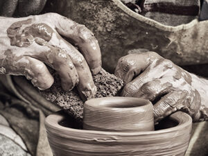 A potter's hands shaping clay