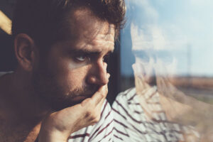 a man staring out through a window