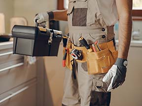 A handyman with a toolbox and toolbelt