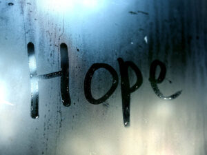 The word HOPE written on misted glass